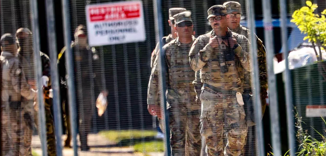 09.10.2025, USA, Broadview: Mitglieder der texanischen Nationalgarde gehen vor dem ICE-Verarbeitungszentrum in Broadview in der Nähe von Chicago. Foto: Stacey Wescott/TNS via ZUMA Press Wire/dpa +++ dpa-Bildfunk +++ (Photo: Stacey Wescott)