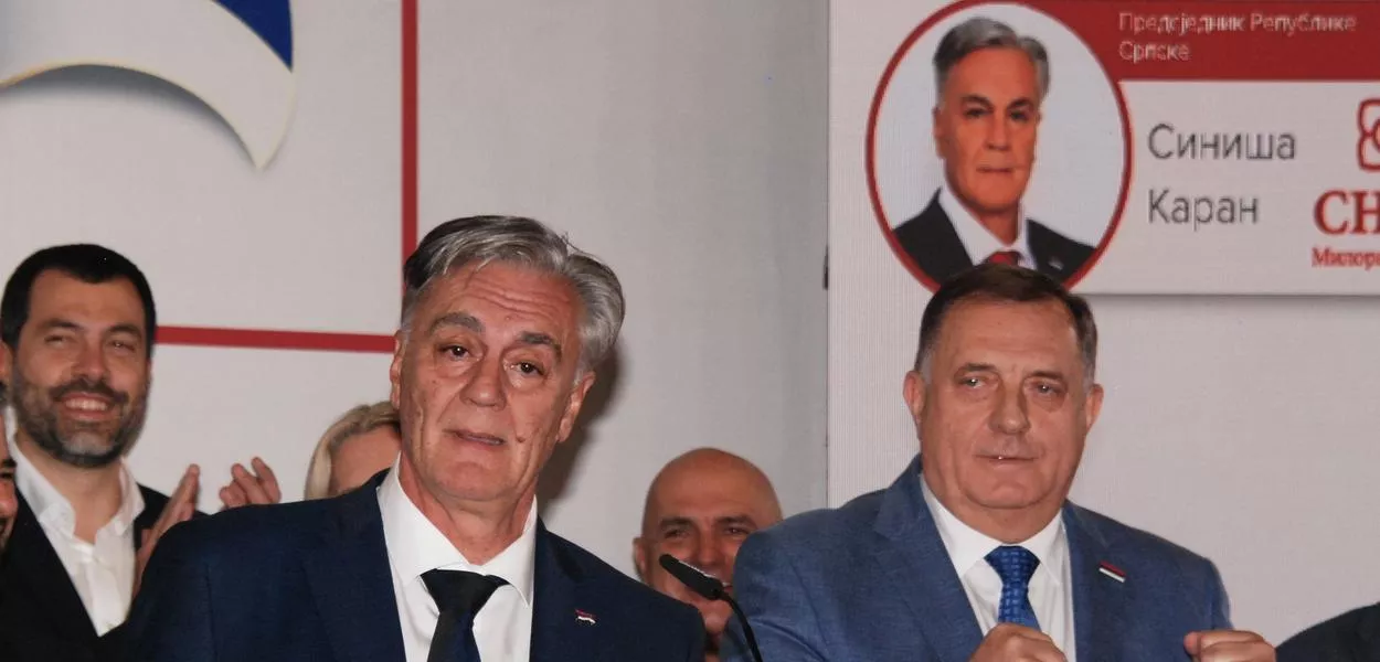 Sinisa Karan, front left, who is backed by former pro-Russian leader Milorad Dodik, right, addresses the media after claiming victory in a snap presidential election of Republika Srpska in Banja Luka, northwest of Sarajevo, Bosnia, Sunday, Nov. 23, 2025. (Photo: AP Photo/Radivoje Pavicic))