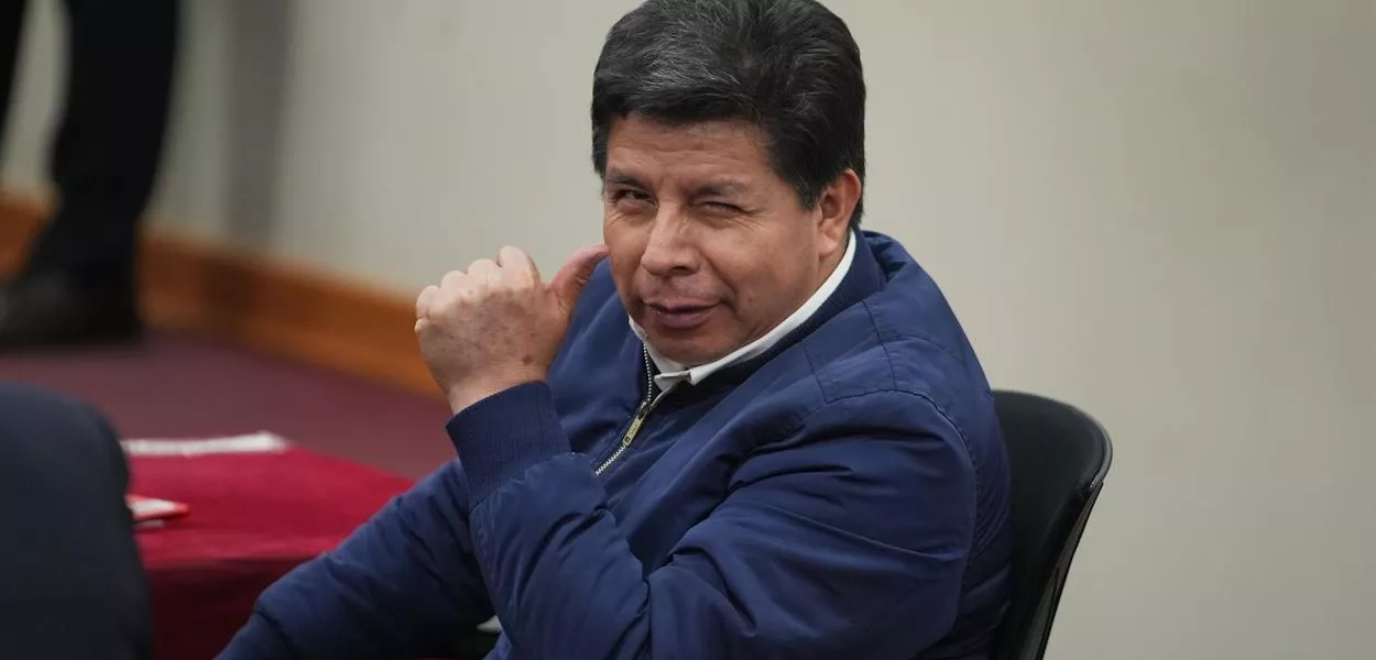 Former President Pedro Castillo, who faces charges of rebellion and other crimes against the state, gestures to the press as he attends his sentence hearing at a police base on the outskirts of Lima, Peru, Thursday, Nov. 27, 2025. (AP Photo/Guadalupe Pardo) (Photo: Guadalupe Pardo)
