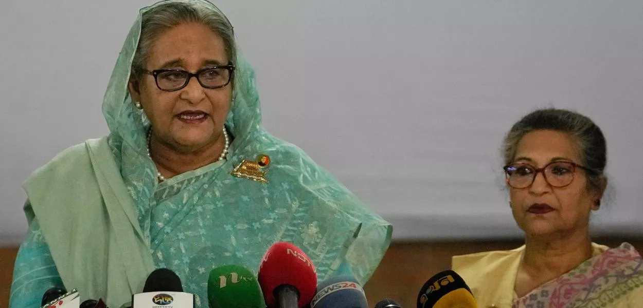 FILE- Bangladesh Prime Minister Sheikh Hasina, left, is flanked by her daughter Saima Wazed Putul, unseen, and sister Sheikh Rehana, right, as she speaks to the media after casting her vote in Dhaka, Bangladesh, on Jan. 7, 2024. (AP Photo/Altaf Qadri, File) (Photo: Altaf Qadri)