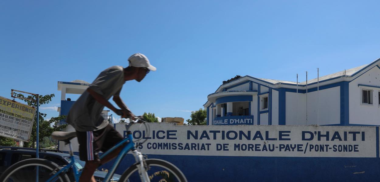 A man rides his bicycle past the police station in Pont-Sonde, Haiti. Next year the country will hold elections for the first time in a decade. (Photo: AP Photo/Odelyn Joseph/File)