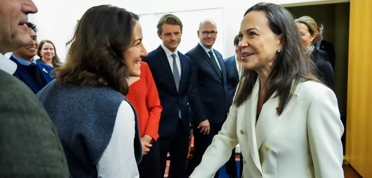 Nobel Peace Prize winner Maria Corina Machado (R) greets Tonje Brenna in the Foreign Affairs Committee as she visits the Norwegian Parliament, the Storting, in Oslo, Norway, on December 11, 2025, one day after the award ceremony for the Nobel Prize. Machado arrived in the Norwegian capital hours after the Venezuelan opposition leader's award was collected on her behalf by her daughter. (Photo by Ole Berg-Rusten / NTB / AFP) / Norway OUT (Photo: OLE BERG-RUSTEN)