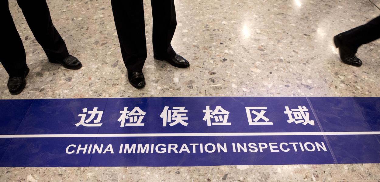 A sign reading “China Immigration Inspection” is displayed on the floor at West Kowloon Station in the Hong Kong Port Area. (Photo: Giulia Marchi)